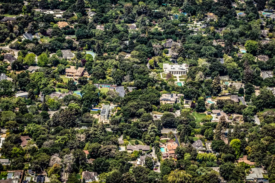 Aerial view of large houses in large yards surrounded by trees in Palo Alto, California